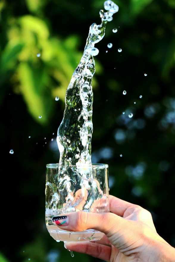 Woman Splashing Water from a Glass 